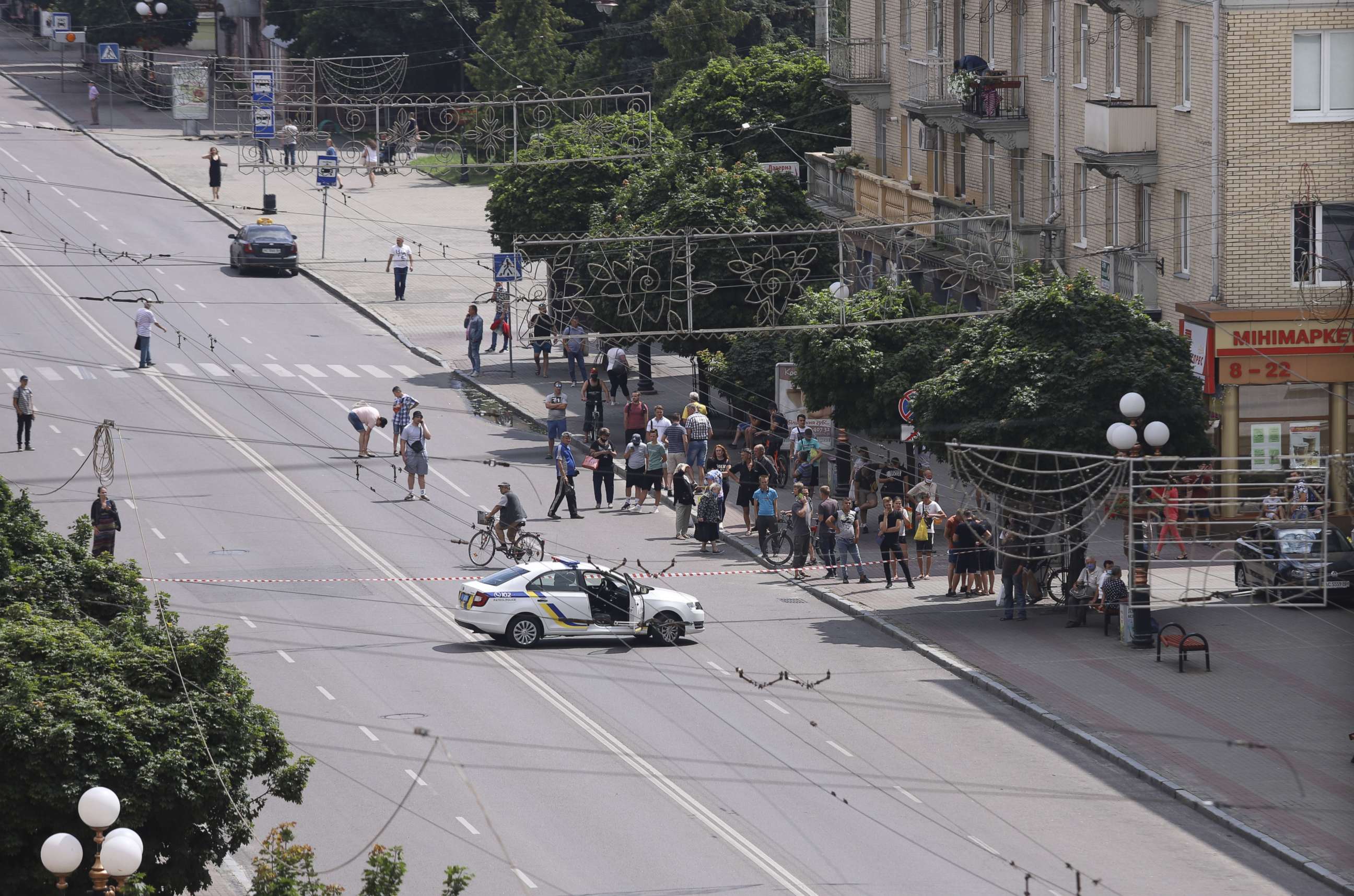 PHOTO: A police car blocks the road where a bus with hostages stays in Lutsk, Ukraine, July 21, 2020. 