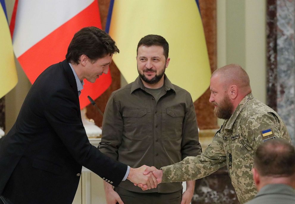 PHOTO: Canadian Prime Minister Justin Trudeau shakes hands with an awarded Ukrainian serviceman as Ukrainian President Volodymyr Zelensky stands near during their meeting at Mariinsky palace in Kyiv, Ukraine, May 8, 2022.
