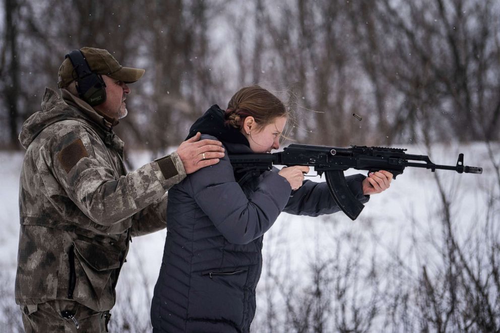 PHOTO: An instructor trains a woman to shoot from a a Kalashnikov assault rifle at a shooting range near Kharkiv, Ukraine's second-largest city, Feb. 6, 2022.