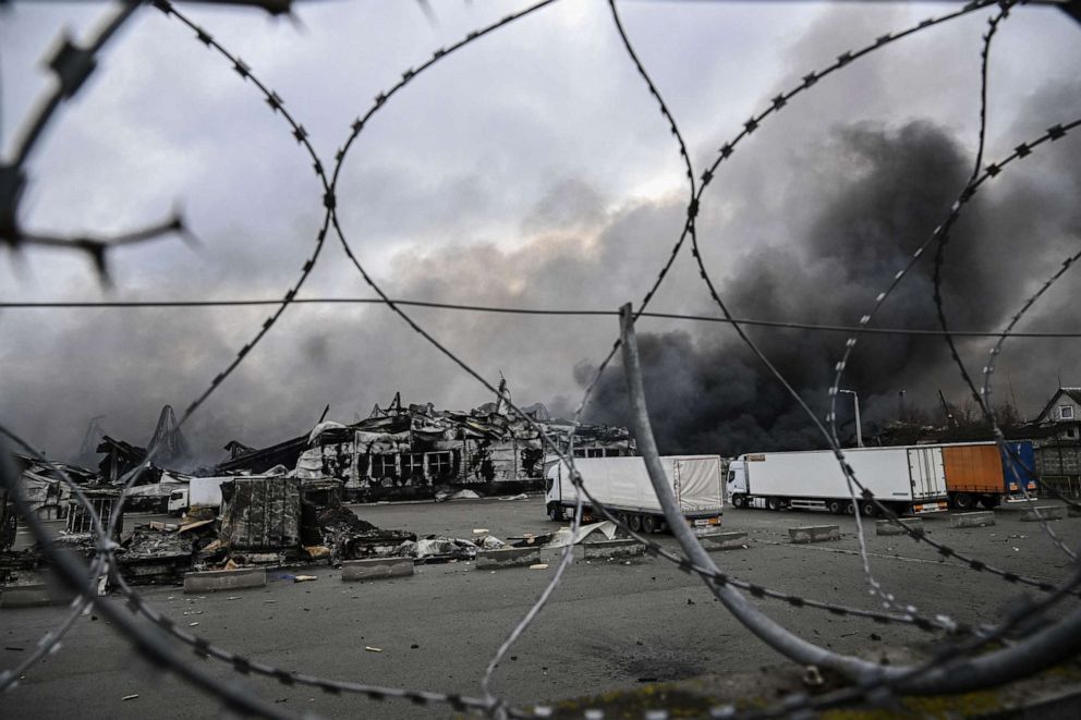 PHOTO: Smoke rises from a bombed warehouse in the town of Stoyanka, west of Kyiv, on March 4, 2022.