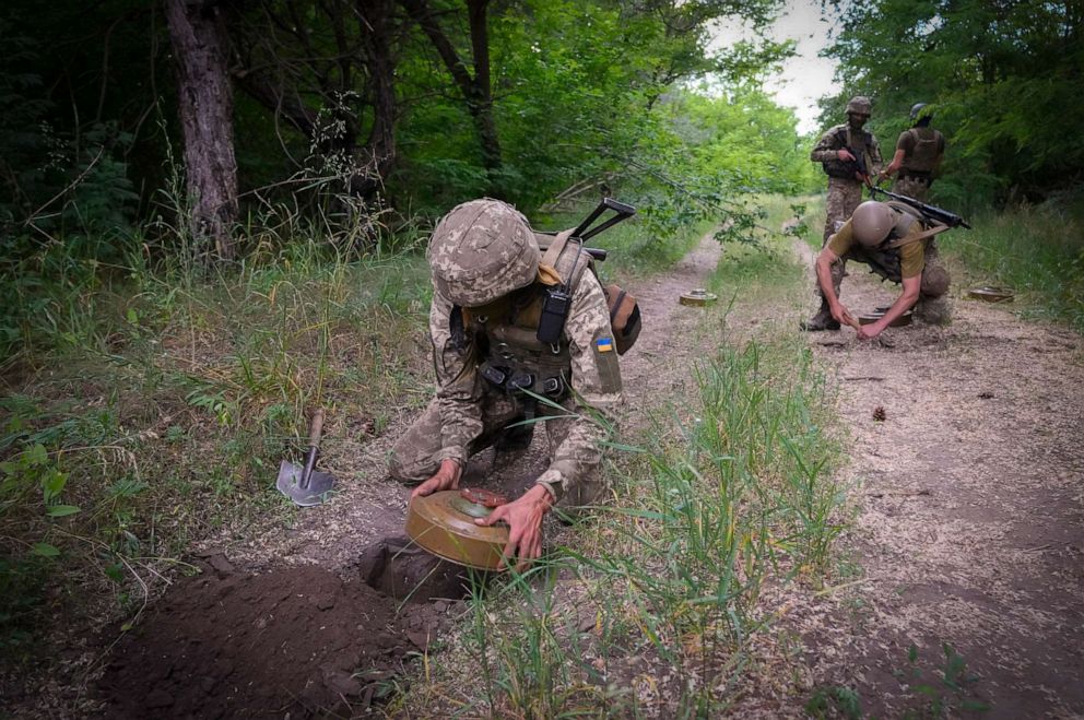 PHOTO: Soldiers of Ukraine's special operations unit lay anti-tank mines on a forest road on the Russian troops' potential way in the Donetsk region, Ukraine, Tuesday, June 14, 2022.