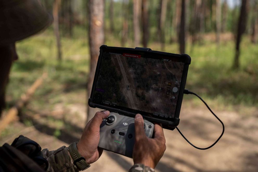 PHOTO: A Ukrainian soldier looks at a Russian tank on his screen while operating a drone to conduct a reconnaissance operation on the outskirts of Kreminna, Ukraine, on Aug. 16, 2023.