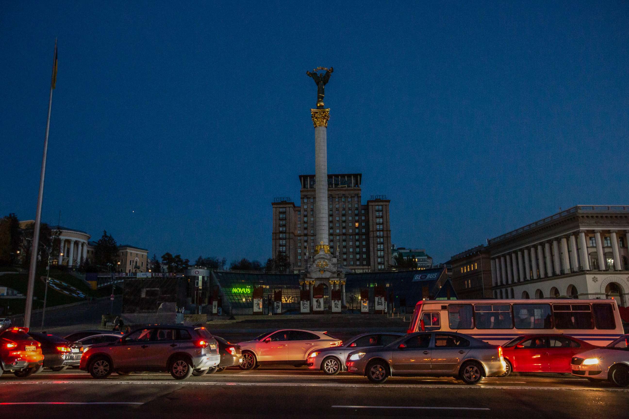 PHOTO: Cars drive along the Independence Square without street lighting in Kyiv, on Oct. 21, 2022.