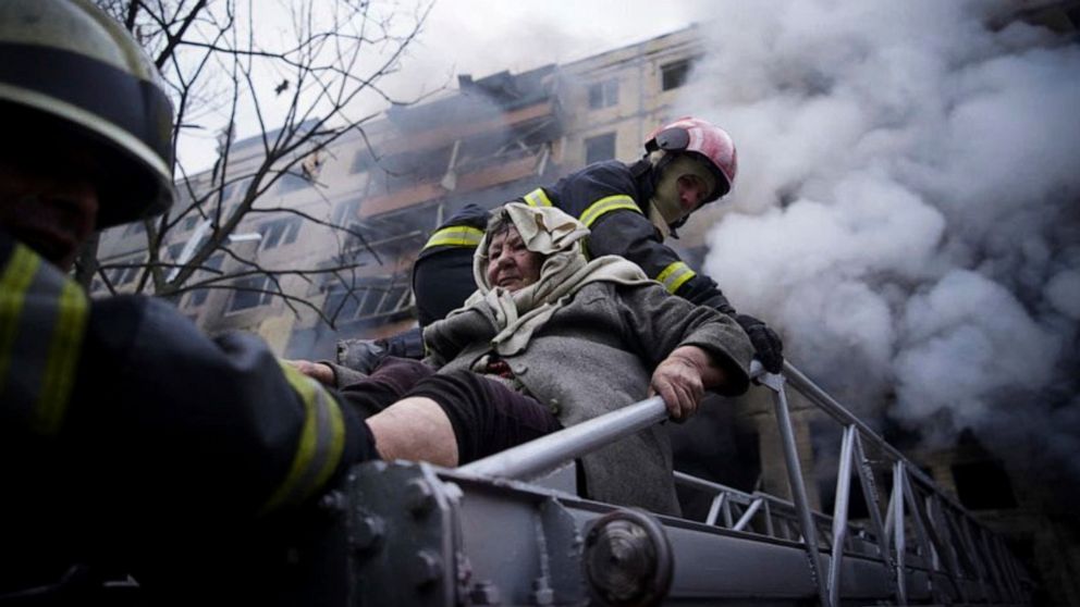 PHOTO: Firefighters evacuate an elderly woman from an apartment building hit by shelling in Kyiv, Ukraine, March 14, 2022.