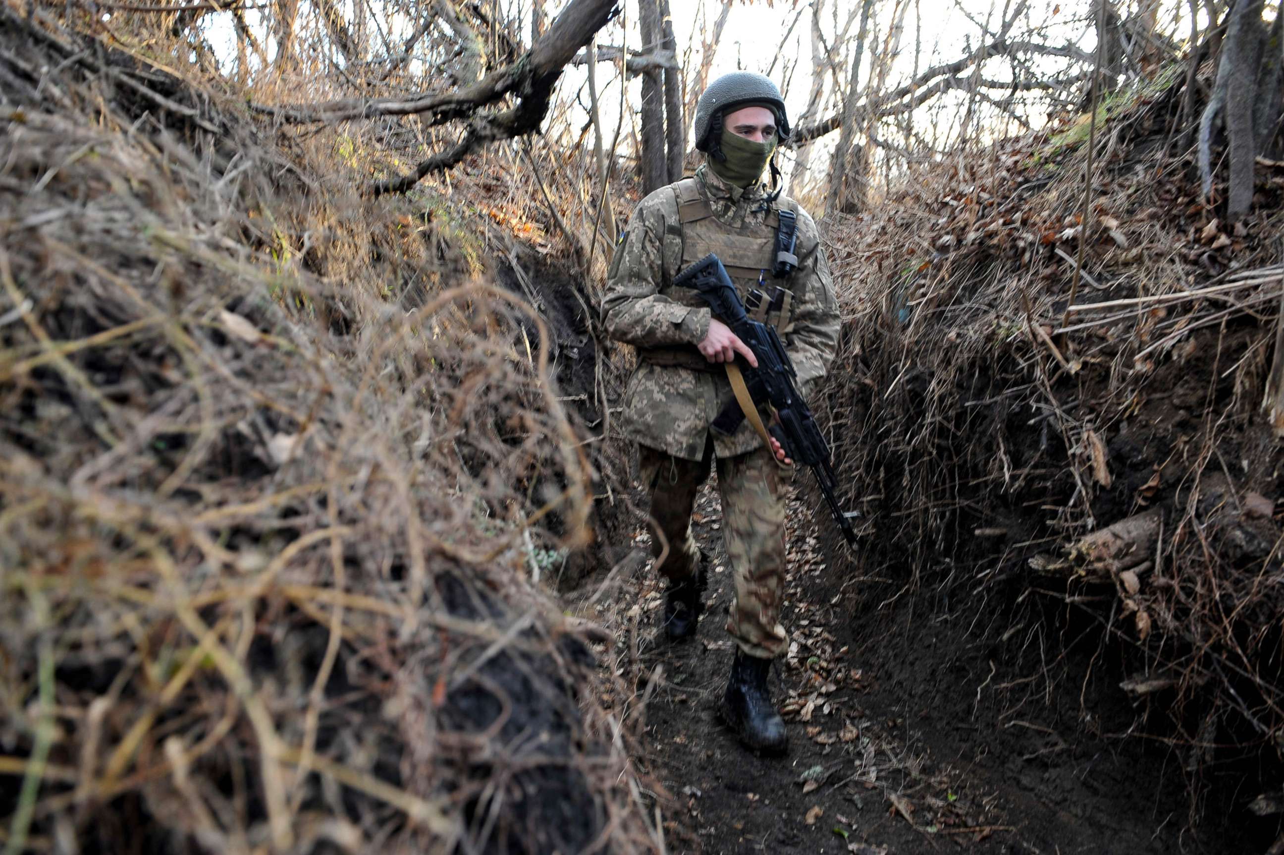 PHOTO: A Ukrainian serviceman walks along a trench on the frontline with Russia-backed separatists near the village of Talakivka, Donetsk region, on Nov. 24, 2021.
