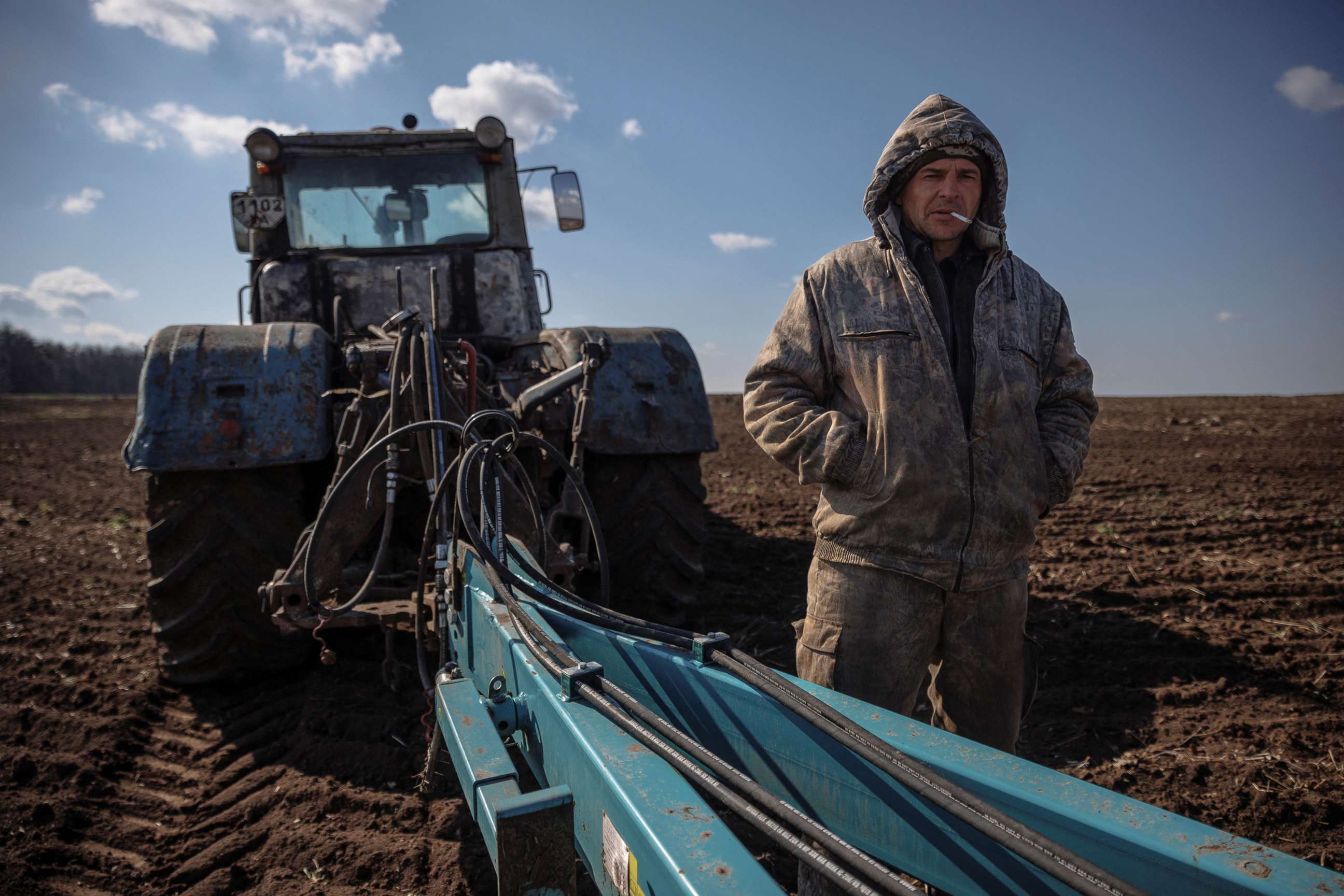 PHOTO: Local farm worker Vladimir takes a break from ploughing a field near the village of Yakovlivka after it was hit by an aerial bombardment outside Kharkiv, as Russia's attack on Ukraine continues, April 5, 2022.