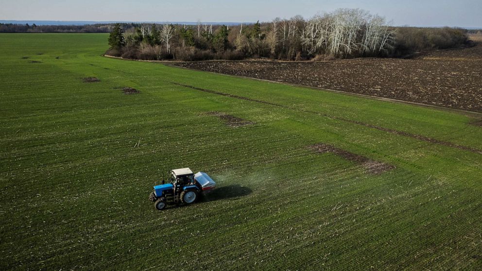PHOTO: An aerial view shows a tractor spreading fertilizer on a wheat field near the village of Yakovlivka outside Kharkiv, as Russia's attack on Ukraine continues, April 5, 2022. 