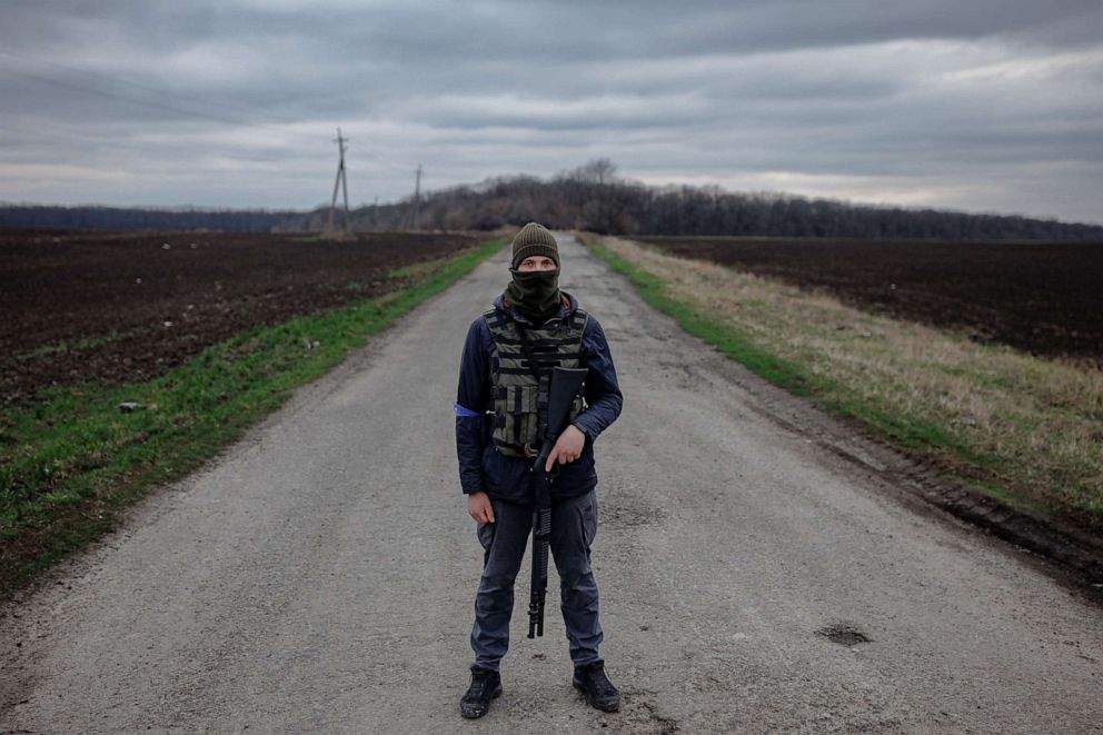 PHOTO: Local farmer Bogdan poses with his gun as he mans a checkpoint outside the village of Yakovlivka after it was hit by an aerial bombardment outside Kharkiv, as Russias attack on Ukraine continues, April 3, 2022. 
