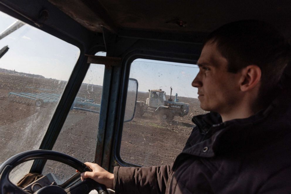 PHOTO: Farm worker Vitaliy drives a tractor pulling a plow on a field near the village of Yakovlivka after it was hit by an aerial bombardment outside Kharkiv, as Russias attack on Ukraine continues, April 5, 2022. 