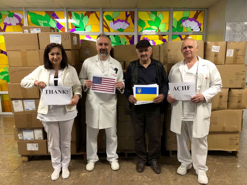 PHOTO: Dr. Vitaly Demyanchuk (2nd from left) and staff from the Ukrainian Health Ministry hold signs to thank the Arlene Campbell Humanitarian Foundation for their donated medical supplies in Kyiv, Ukraine.