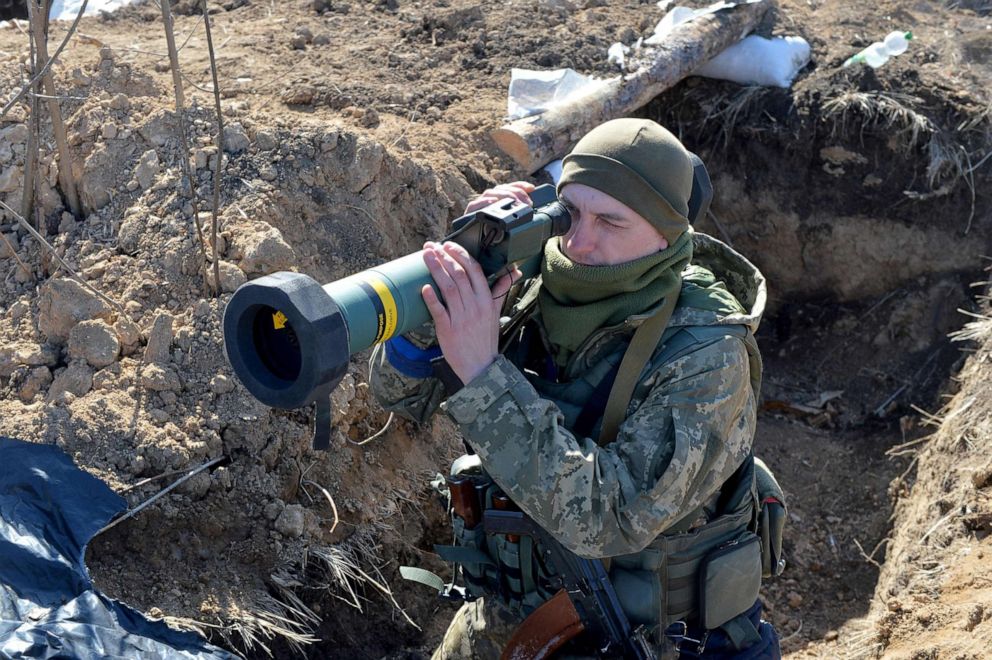 PHOTO: A serviceman of Ukrainian military forces holds a FGM-148 Javelin, an American-made portable anti-tank missile, at a checkpoint, where they hold a position near Kharkiv, Ukraine, on March 23, 2022. 
