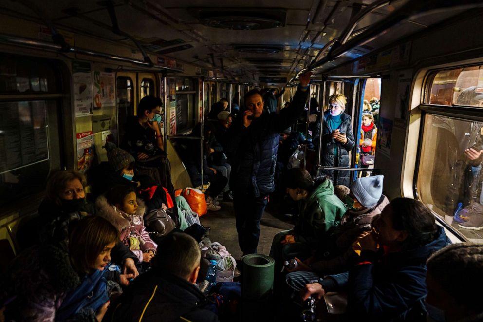 PHOTO: Hundreds of people seek shelter underground, on the platform, inside the dark train cars, and even in the emergency exits, in metro subway station as the Russian invasion of Ukraine continues, in Kharkiv, Ukraine, on Feb. 24, 2022.