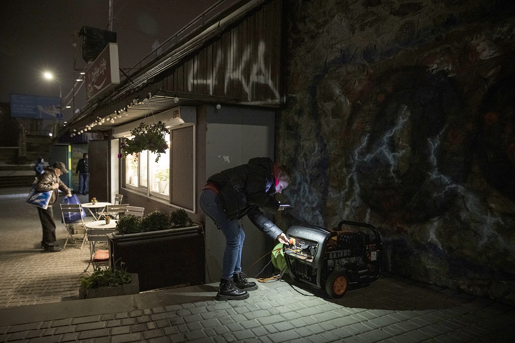 PHOTO: A woman checks on a generator that powers a cafe if there is a power cut in Kyiv, Ukraine, Nov. 5, 2022.