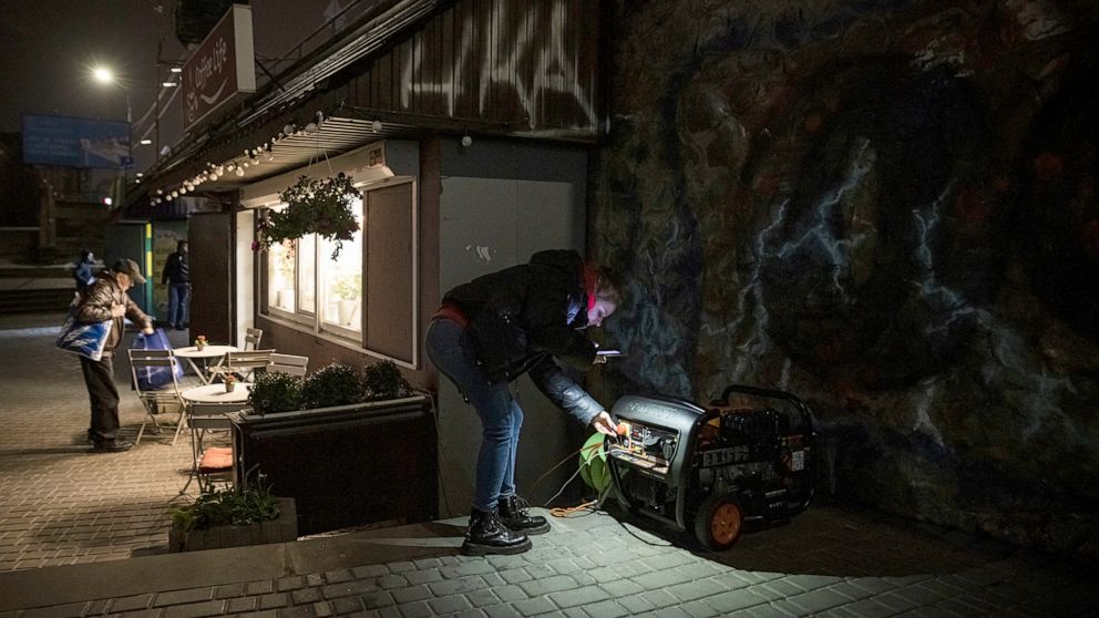 PHOTO: A woman checks on a generator that powers a cafe if there is a power cut in Kyiv, Ukraine, Nov. 5, 2022.