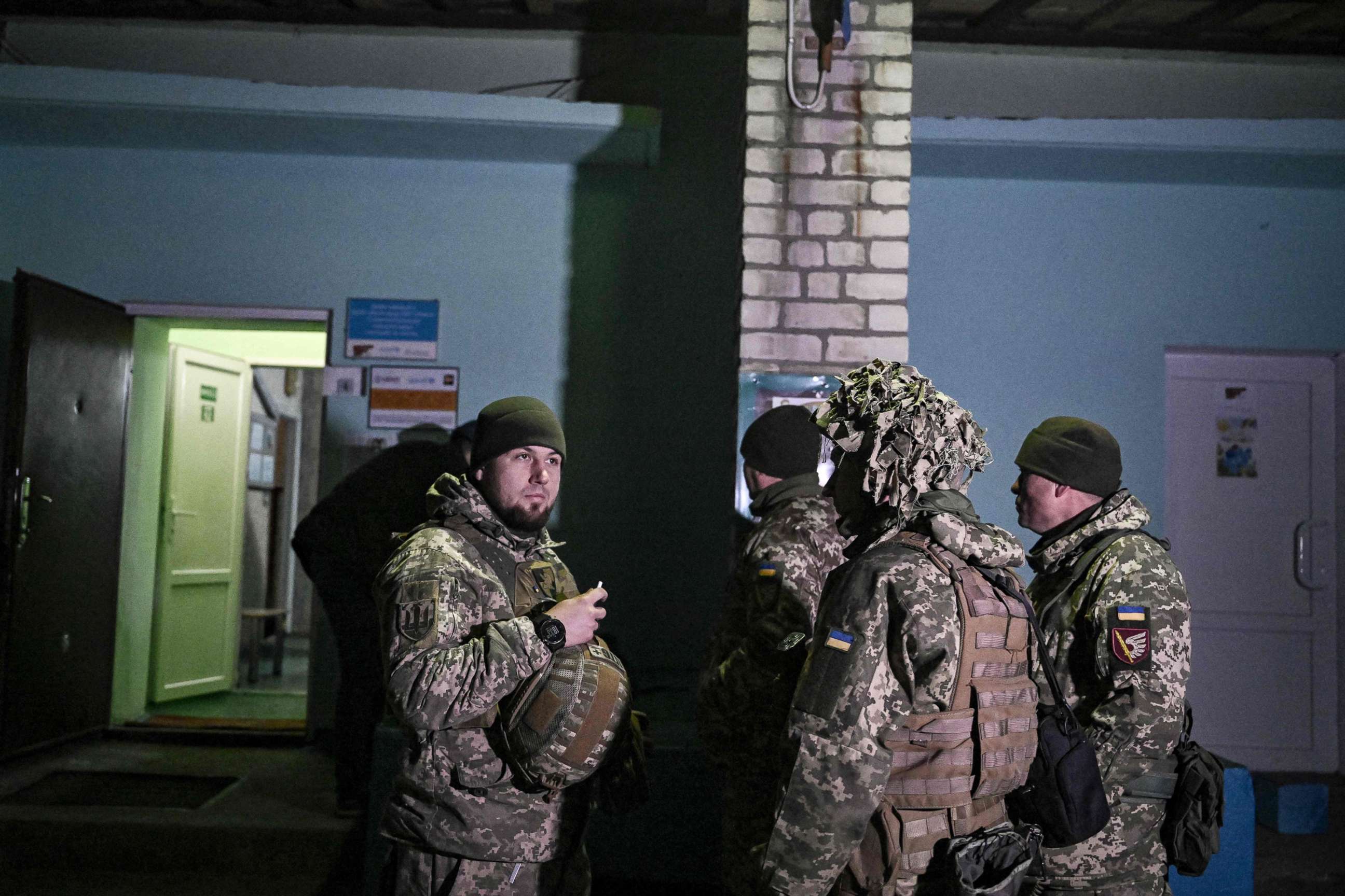 PHOTO: Ukrainian soldiers stand guard outside the building after the reported shelling of a kindergarden in the settlement of Stanytsia Luhanska, Ukraine, on Feb. 17, 2022.