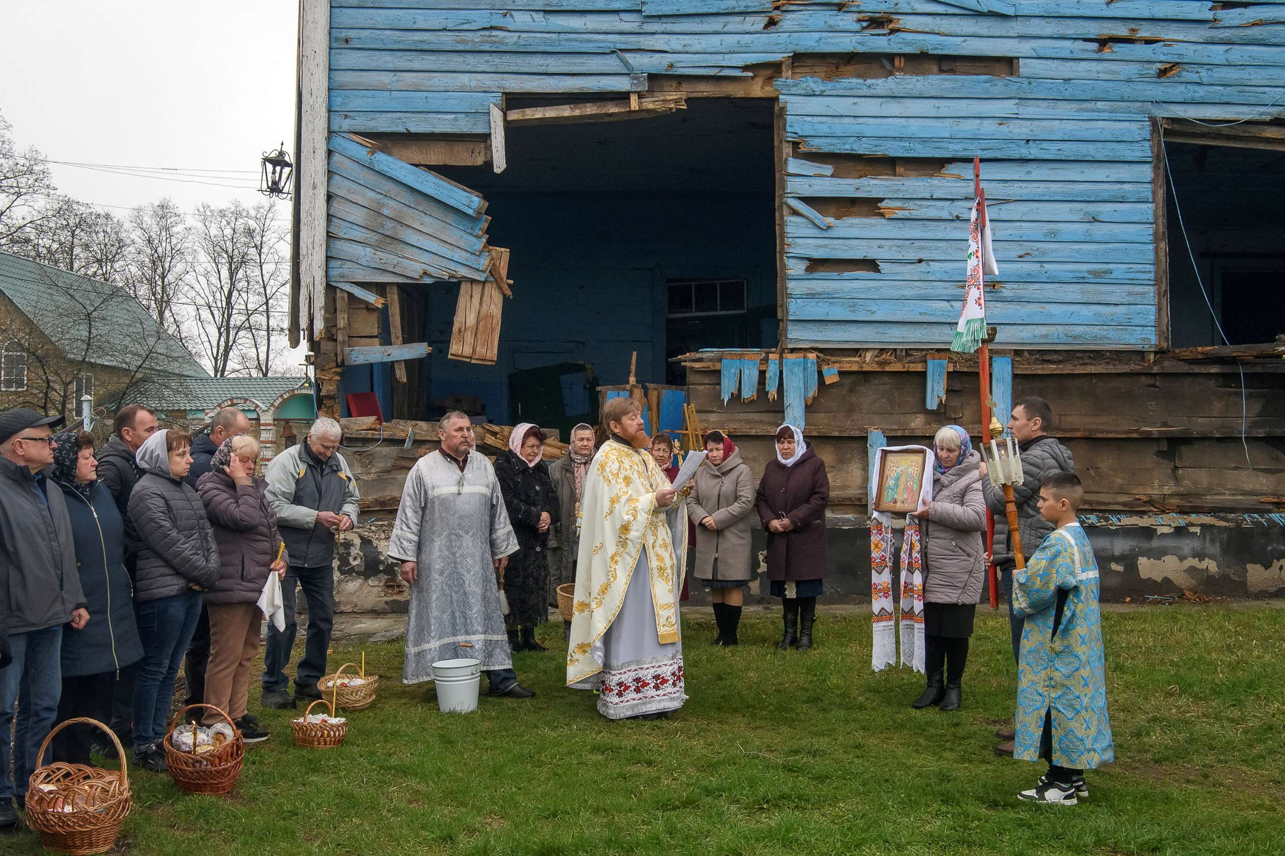 PHOTO: An Orthodox priest Oleksandr conducts the Orthodox Easter service next to The Nativity of the Holy Virgin Church damaged by shelling during Russia's invasion in the village of Peremoha, in Kyiv region, Ukraine April 24, 2022. 