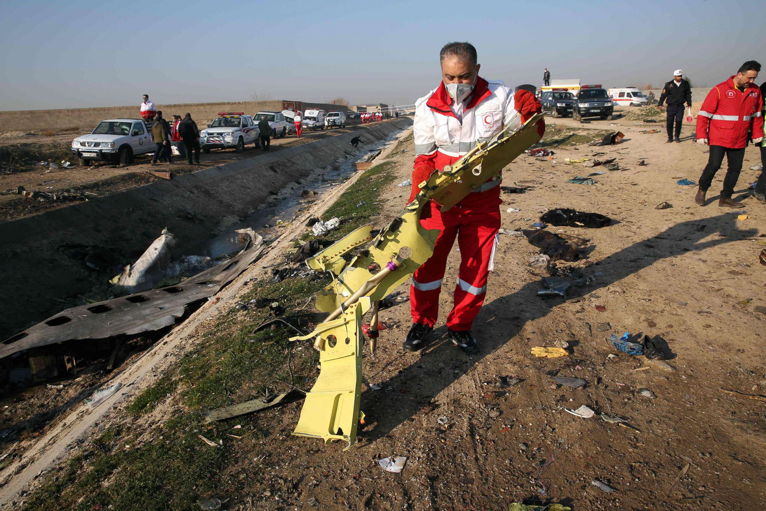 PHOTO: Rescue teams recover debris from a field after a Ukrainian plane carrying 176 passengers crashed near Imam Khomeini airport in the Iranian capital Tehran early in the morning on Jan. 8, 2020, killing everyone on board.