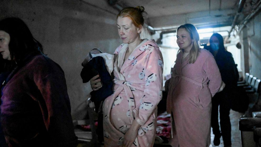 PHOTO: Pregnant women walk in a basement of maternity hospital as sirens warning for air raids in Mykolaiv, on March 14, 2022.