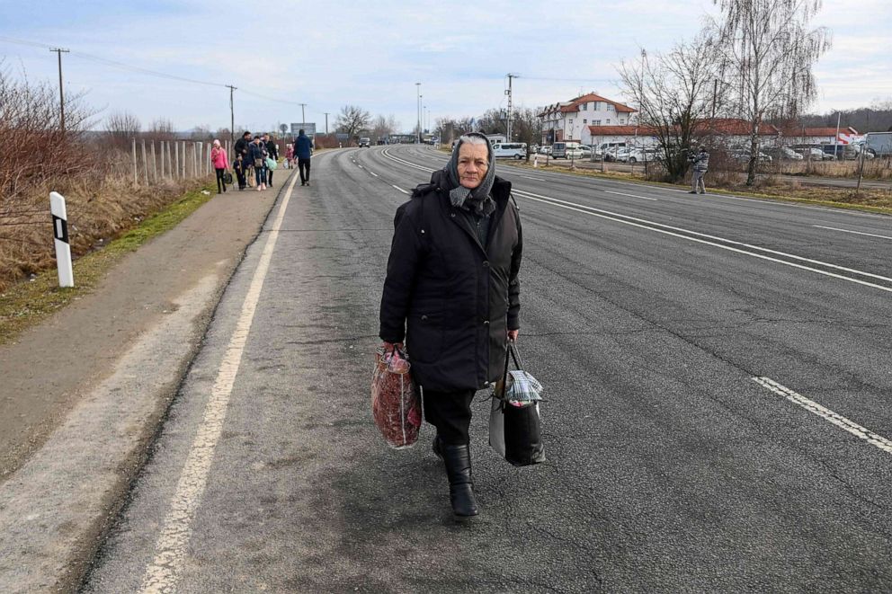 PHOTO: An elderly woman walks along a road near the Hungarian-Ukrainian border crossing near Beregsurany, Hungary, some 300 km from the Hungarian capital on Feb. 25, 2022, as Ukrainian citizens have started to flee the conflict in their country.
