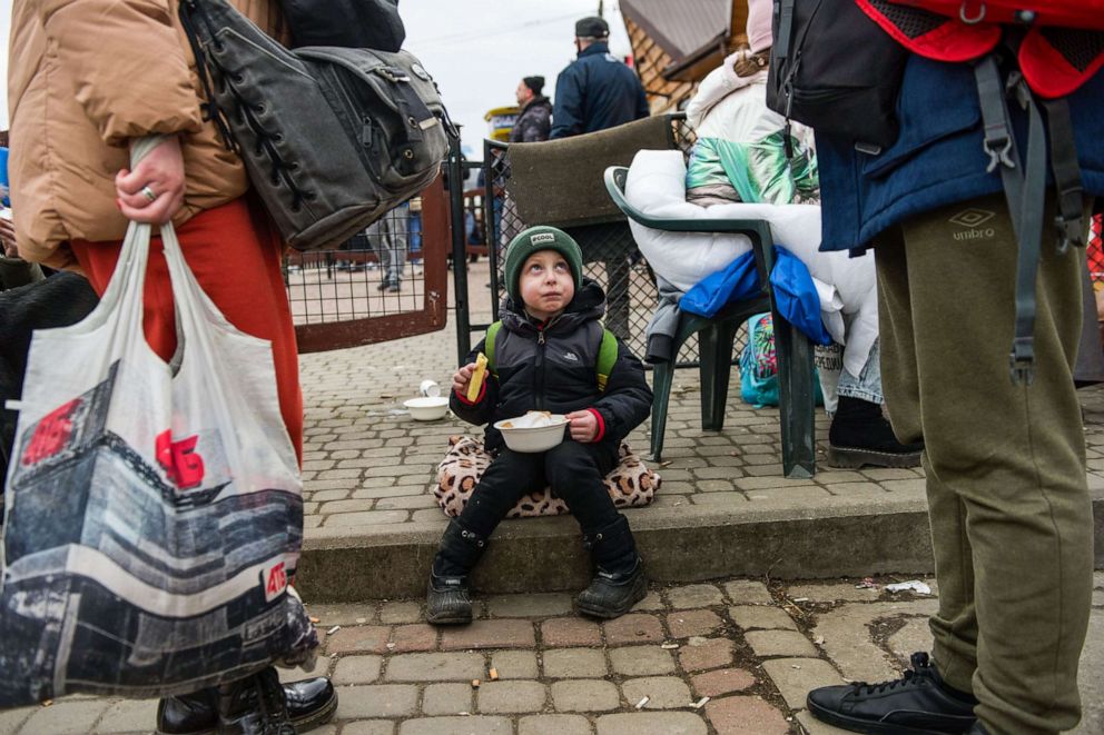 PHOTO: A refugee child is seen eating at the food distribution point at the border crossing in Medyka, Poland, Feb. 25, 2022.