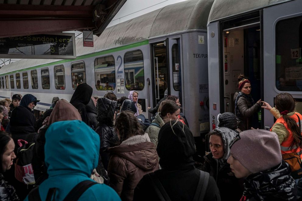 PHOTO: Ukrainian evacuees board to a train en route to Warsaw at the rail station in Przemysl, near the Polish-Ukrainian border, March 26, 2022, following Russia's military invasion launched on Ukraine.