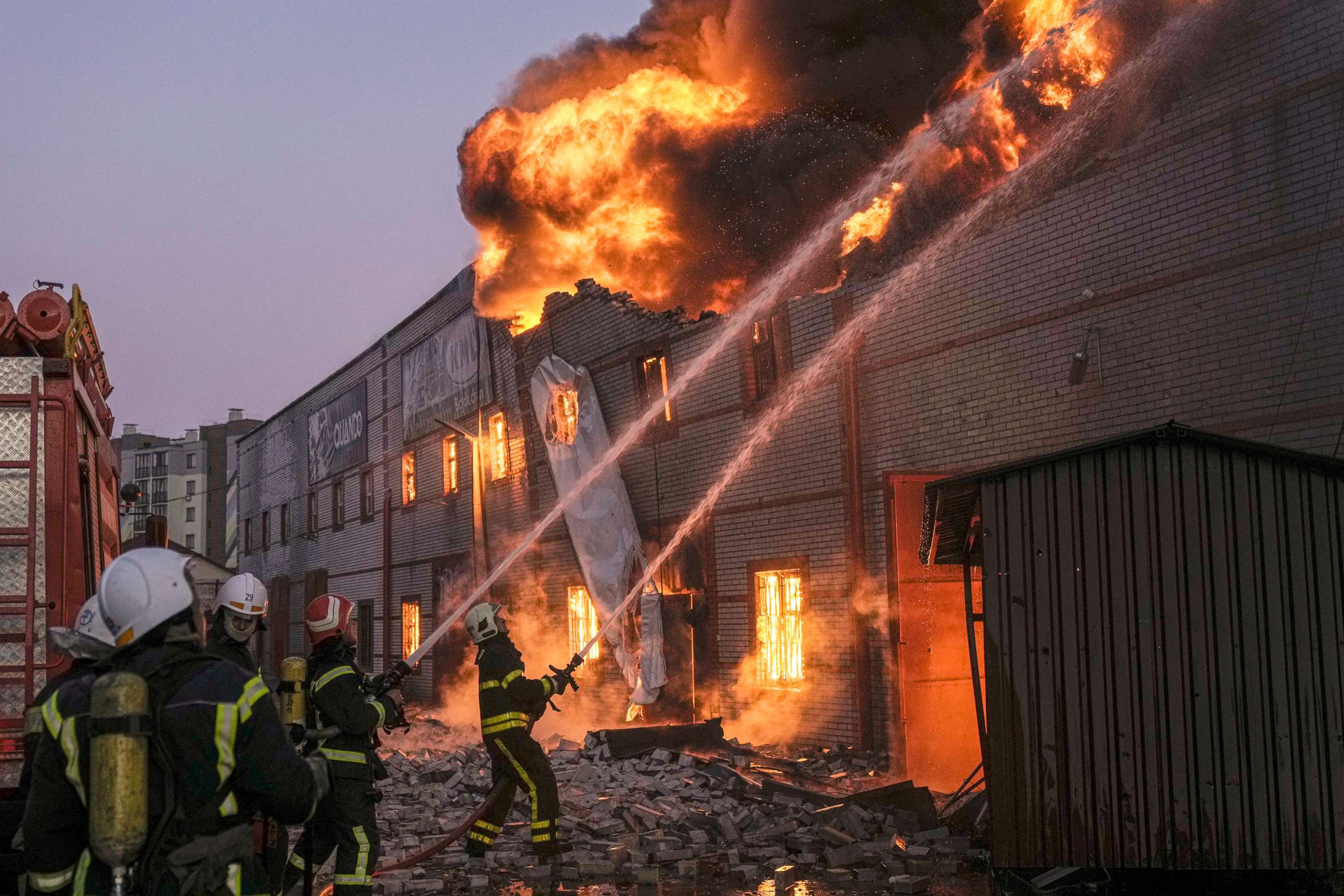 PHOTO: Ukrainian firefighters extinguish a blaze at a warehouse after a bombing in Kyiv, Ukraine, March 17, 2022. 