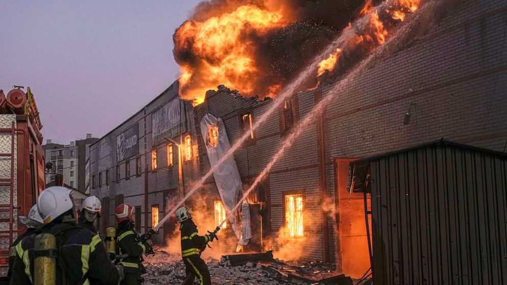 PHOTO: Ukrainian firefighters extinguish a blaze at a warehouse after a bombing in Kyiv, Ukraine, March 17, 2022. 