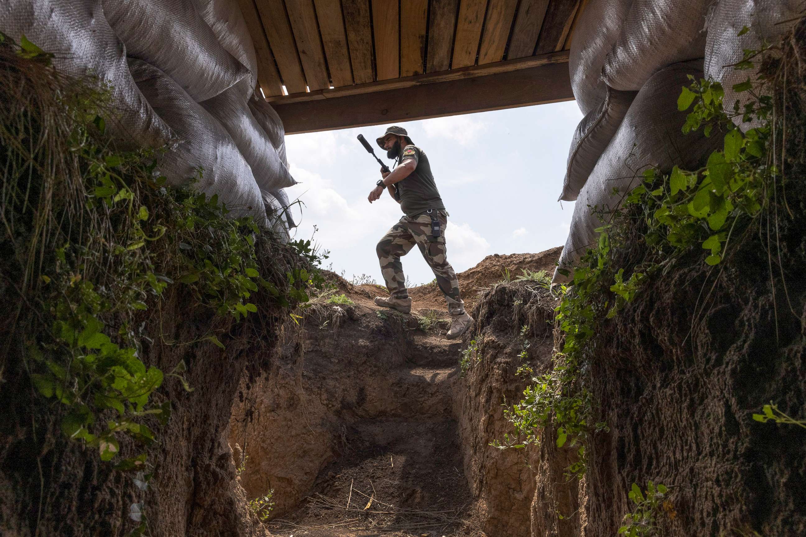 PHOTO: A fighter with Dnipro-1, a unit in Ukraine's National Guard, walks through a bunker position along the frontline outside of Sloviansk, Ukraine, Aug. 3, 2022.