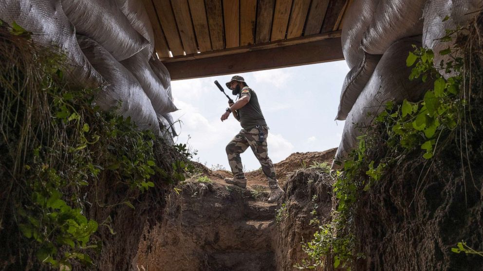 PHOTO: A fighter with Dnipro-1, a unit in Ukraine's National Guard, walks through a bunker position along the frontline outside of Sloviansk, Ukraine, Aug. 3, 2022.