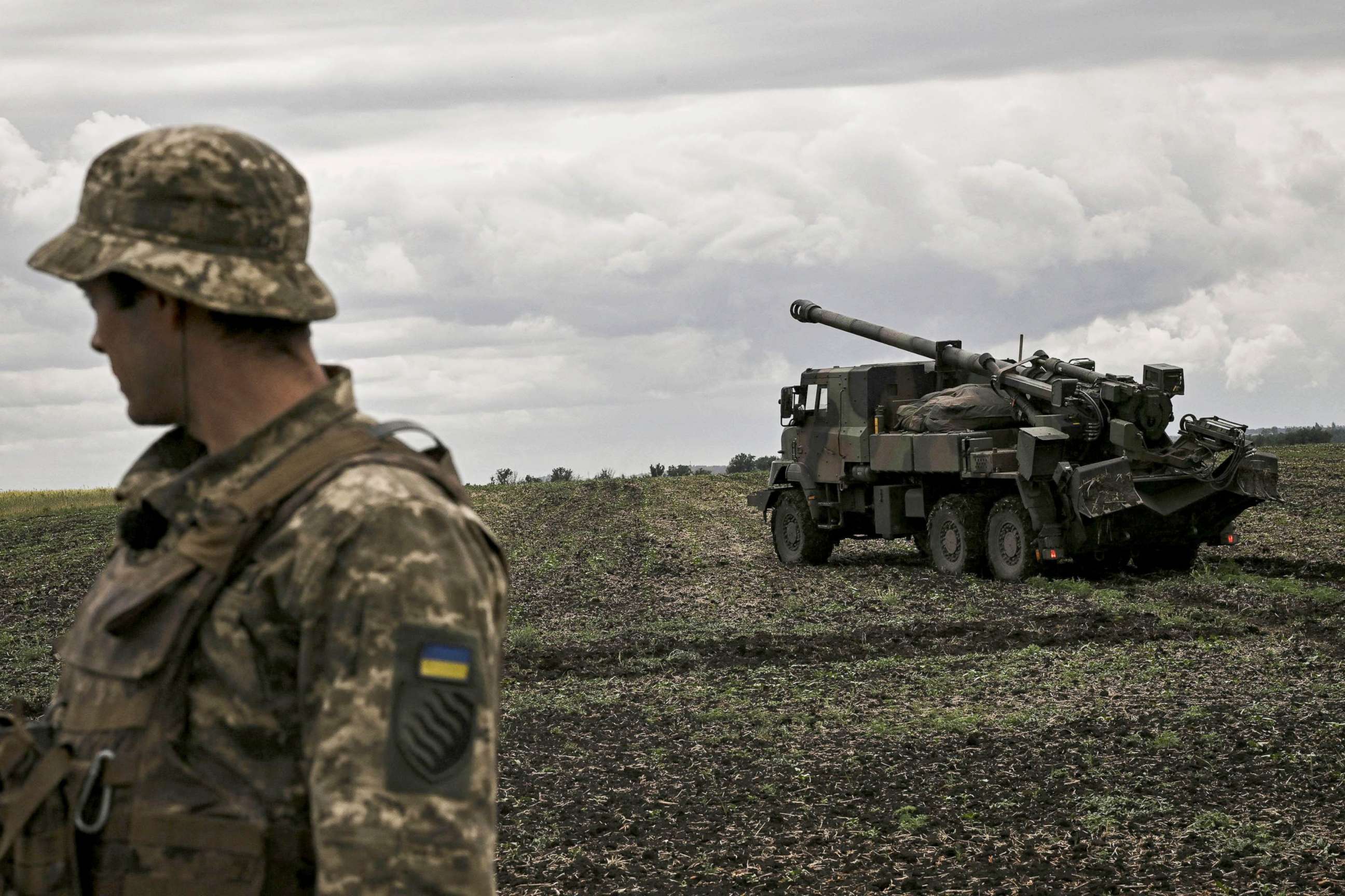 PHOTO: An Ukrainian officer stands in front of a French self-propelled 155 mm/52-calibre gun Caesar at a front line in the eastern Ukrainian region of Donbas, June 15, 2022.