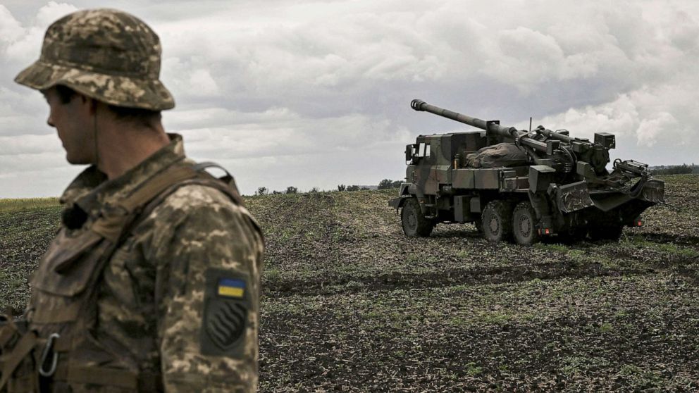PHOTO: An Ukrainian officer stands in front of a French self-propelled 155 mm/52-calibre gun Caesar at a front line in the eastern Ukrainian region of Donbas, June 15, 2022.