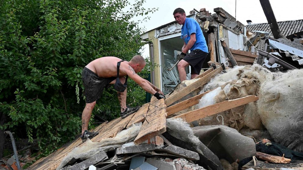 PHOTO: Local residents remove the debris from their partially destroyed house after a Russian rocket explosion on the outskirts of Kharkiv, Ukraine, July 10, 2022.