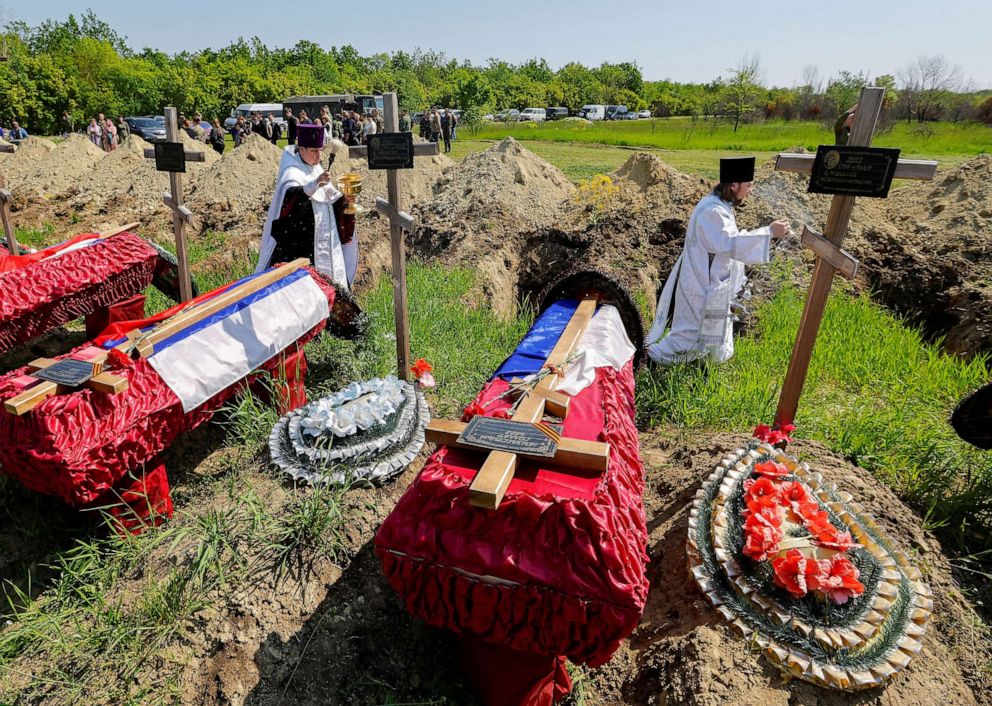 PHOTO: Clergymen take part in a funeral ceremony to bury the remains of members of the Russian armed forces and three civilians, who were killed in the course of Russia-Ukraine conflict, at a cemetery in Luhansk, Russian-controlled Ukraine, May 18, 2023.