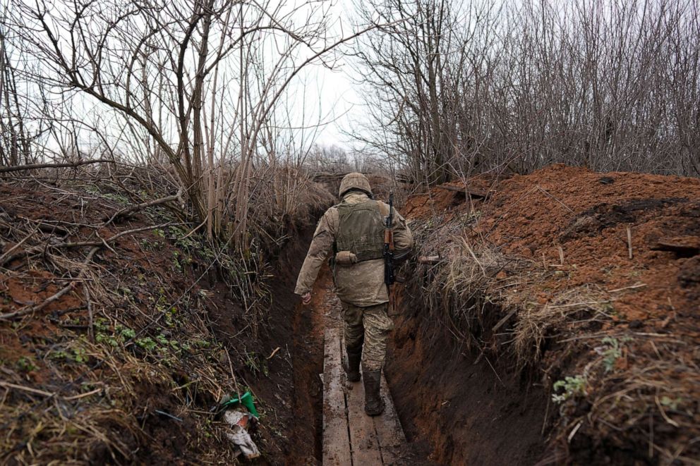 PHOTO: A Ukrainian serviceman walks in a trench at his position at the line of separation between Ukraine-held territory and rebel-held territory near Svitlodarsk, eastern Ukraine, Feb. 23, 2022.
