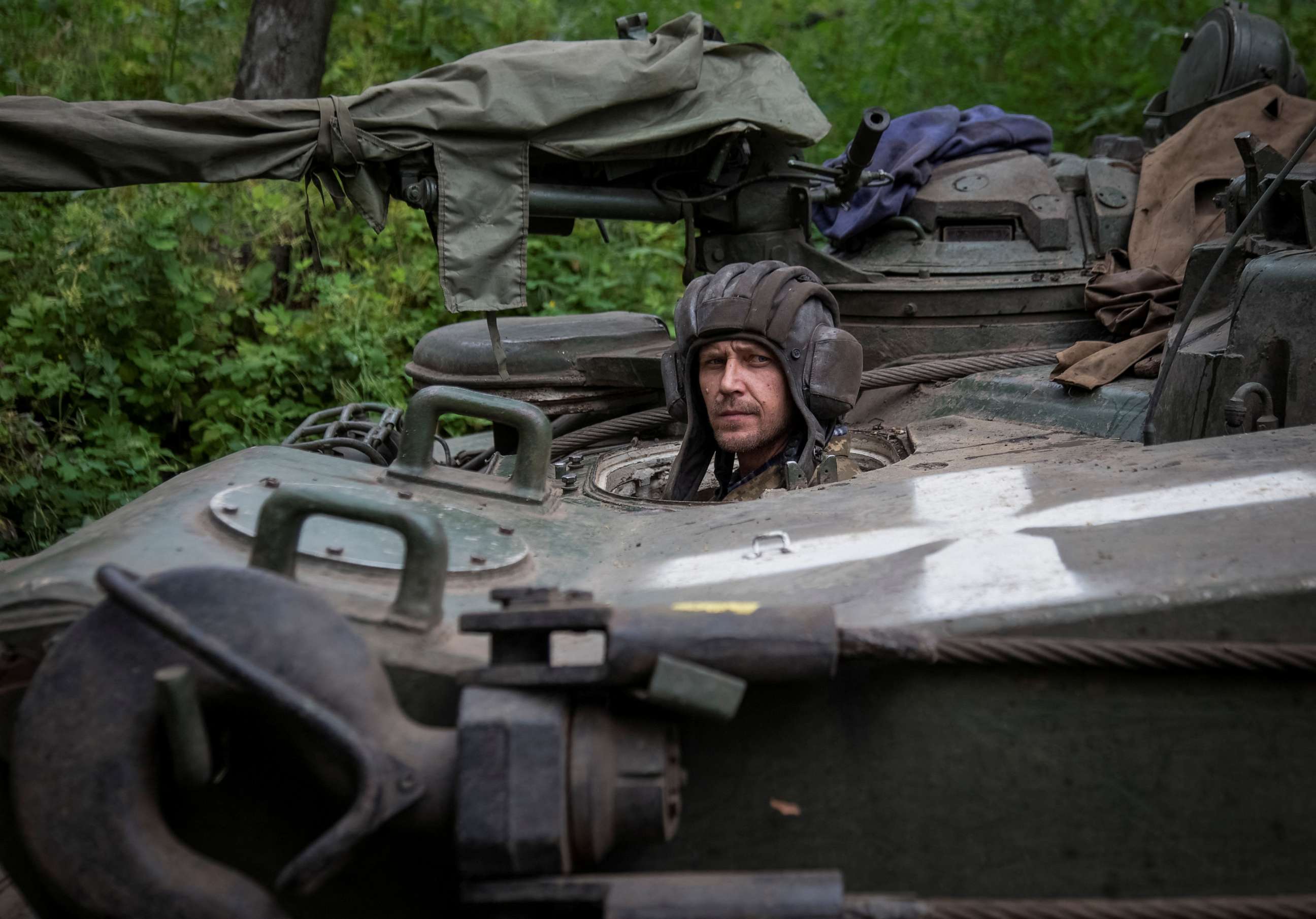 PHOTO: A Ukrainian serviceman looks out of an armored recovery military vehicle, amid Russia's attack on Ukraine, in Donetsk region, Ukraine, June 12, 2023.