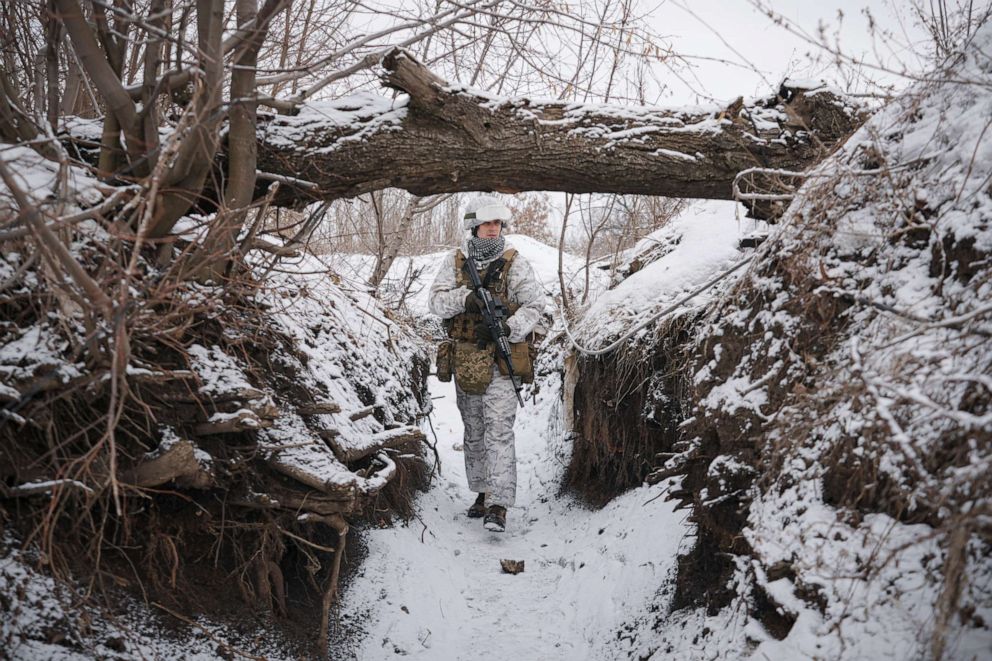 PHOTO: Ukrainian serviceman Ivan Skuratovskyi walks in a trench at a frontline position outside Avdiivka, Donetsk region, eastern Ukraine, Friday, Feb. 4, 2022.