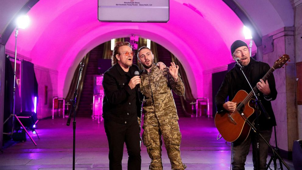 PHOTO: Bono, The Edge and Ukrainian serviceman, frontman of the Antytila band Taras Topolia sing during a performance for Ukrainian people inside a subway station in Kyiv, Ukraine May 8, 2022.
