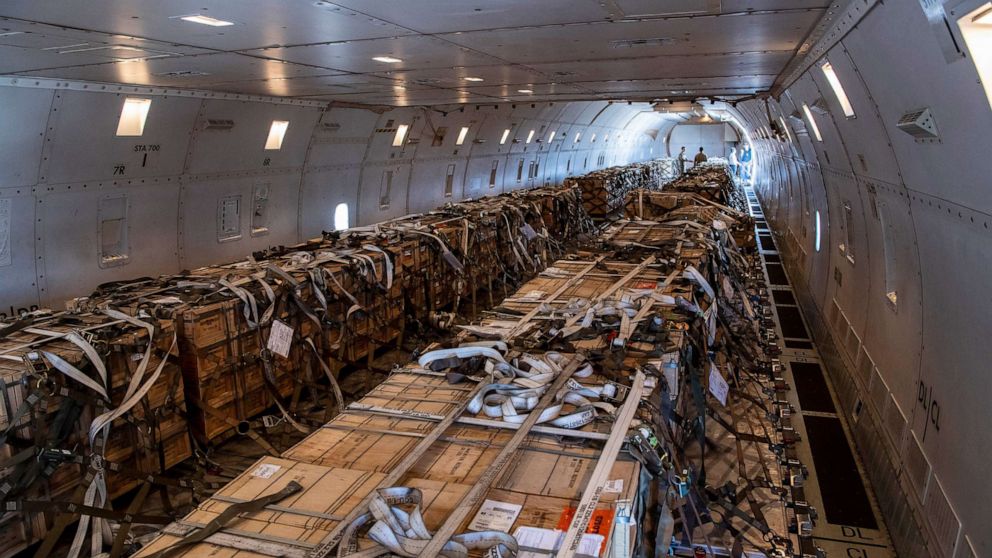 PHOTO: U.S. Air Force Airmen from the 60th Aerial Port Squadron load cargo on to a 757 at Travis Air Force Base, Calif., Jan. 22, 2022.