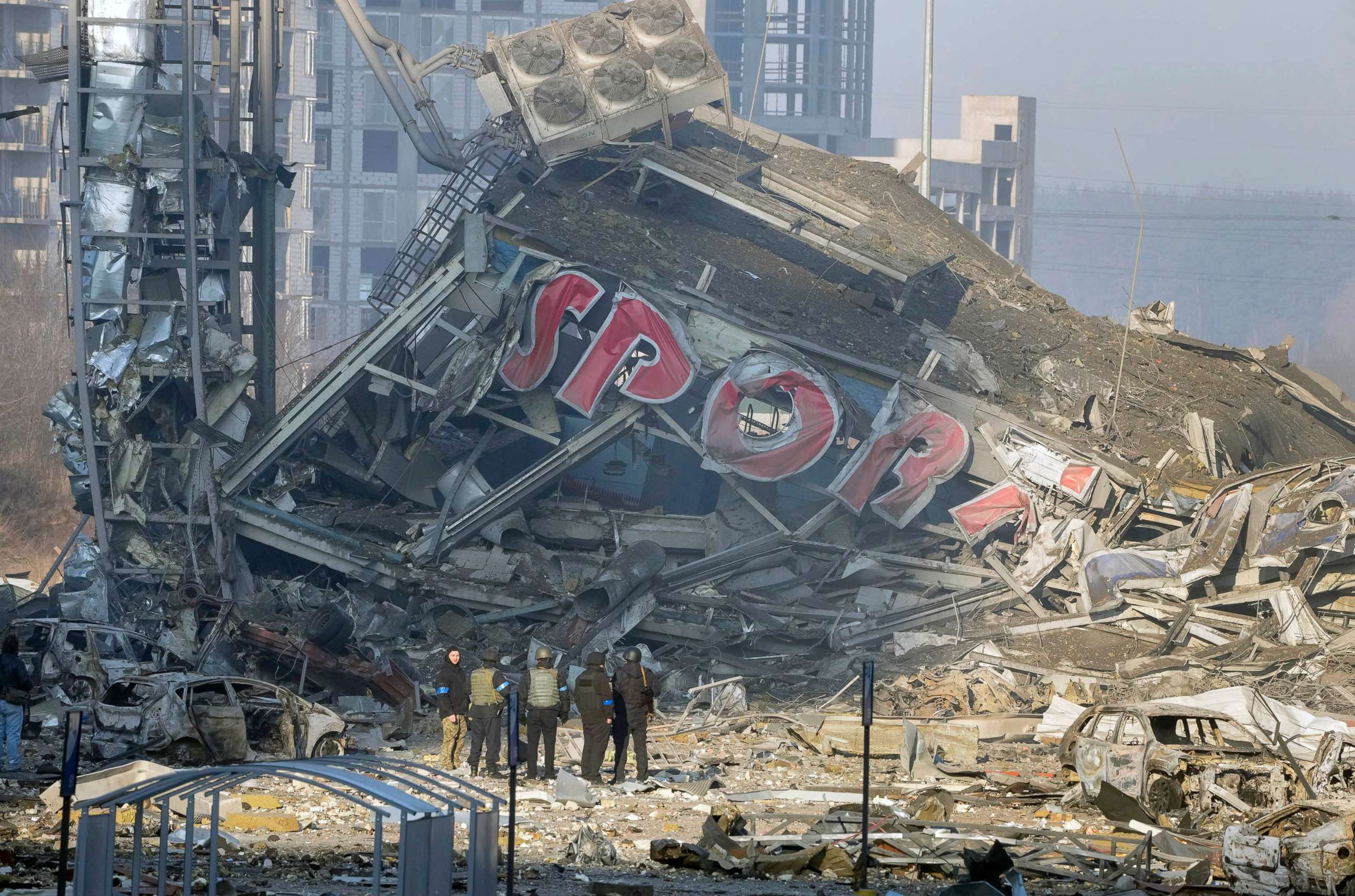 PHOTO: People examine the damage after shelling of a shopping center, in Kyiv, Ukraine, March 21, 2022.