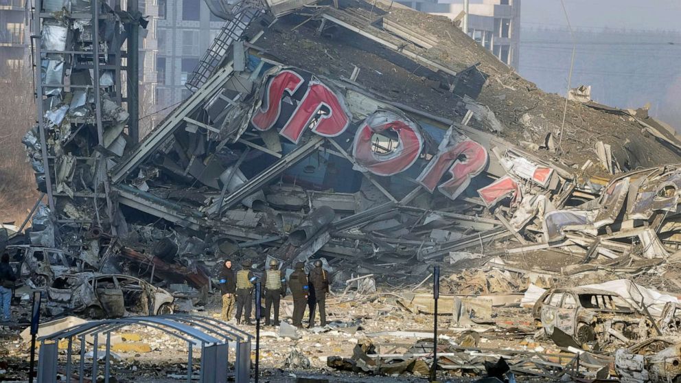 PHOTO: People examine the damage after shelling of a shopping center, in Kyiv, Ukraine, March 21, 2022.