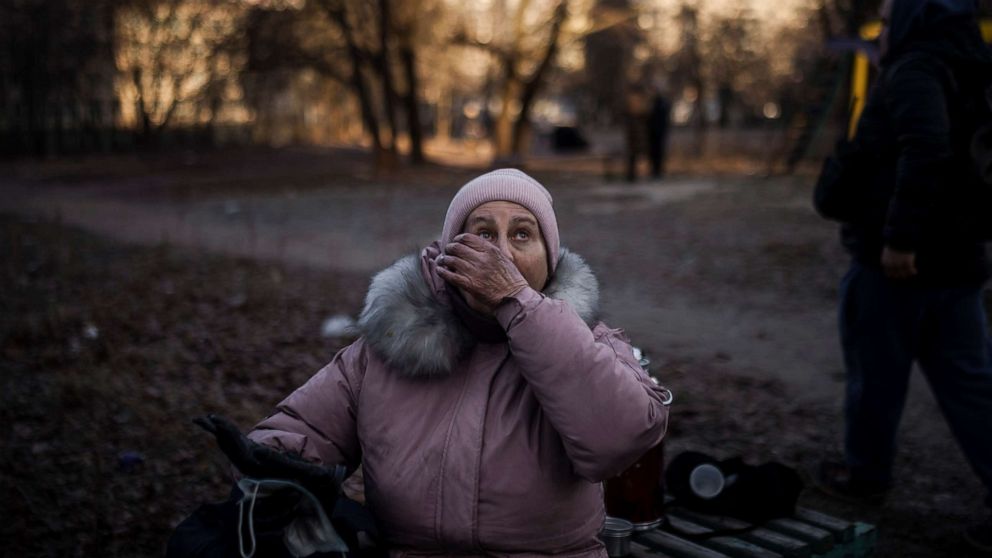 PHOTO: A woman reacts after being rescued by firefighters from her apartment in a burning building in Kyiv, Ukraine, March 15, 2022.