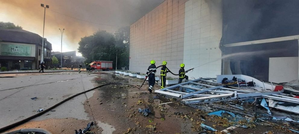 PHOTO: escuers work at a site of a shopping mall hit by a Russian missile strike, ain Kremenchuk, in Poltava region, Ukraine, June 27, 2022.