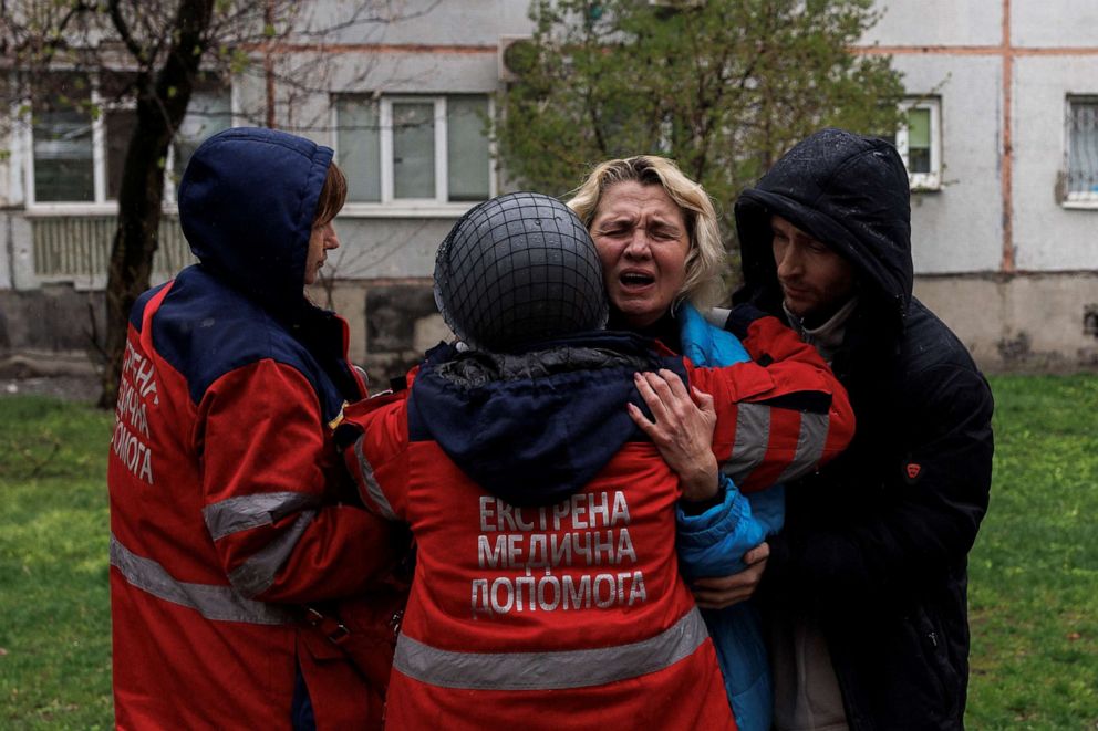 PHOTO: Yana Bachek mourns in the arms of a medical worker, after her father, Victor Gubarev, was killed by Russian shelling, as Russia's attack on Ukraine continues, in Kharkiv, Ukraine, April 18, 2022.