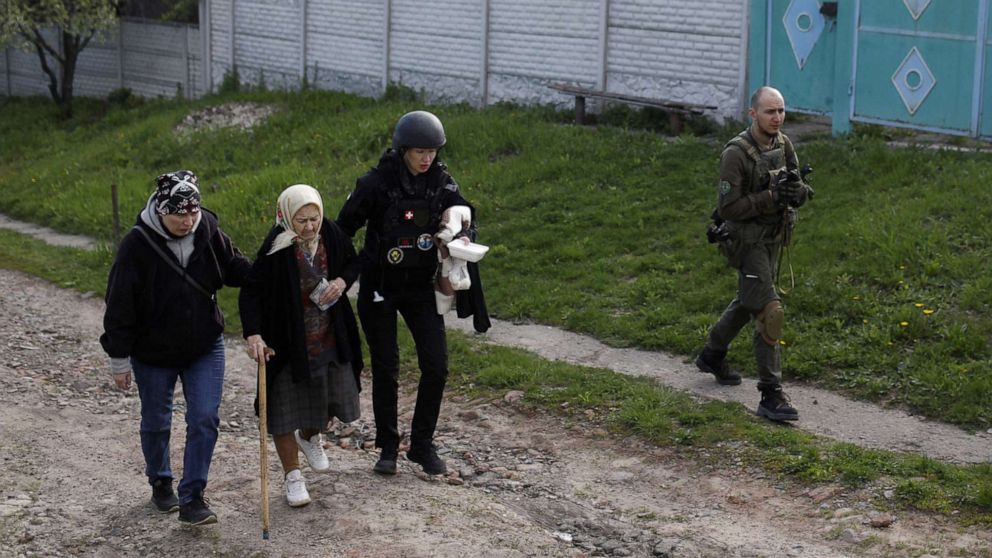PHOTO: A resident is evacuated by volunteers from a village retaken by Ukrainian forces, next to a frontline, near Kharkiv, Ukraine, May 2, 2022.