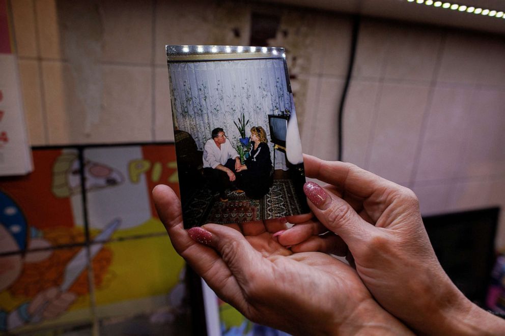PHOTO: Yana Bachek holds a photo of her mother Luybov Gubareva and her father Victor Gubarev, 79, killed by shelling during Russia's invasion of Ukraine, in Kharkiv, Ukraine, April 20, 2022.