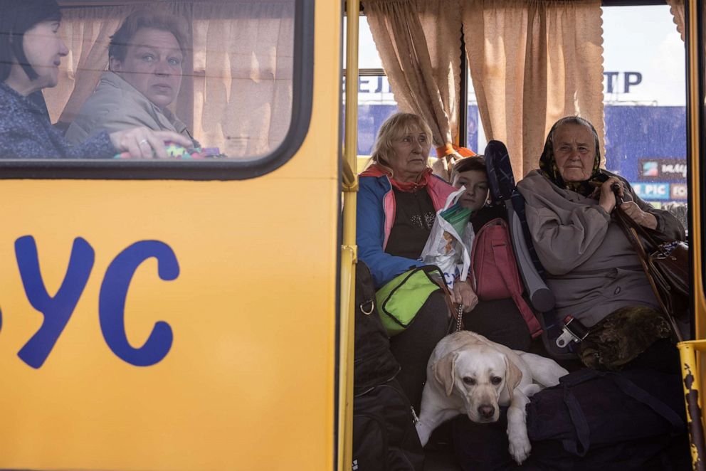 PHOTO: Women from the frontline town of Orikhiv wait on a bus after arriving in Zaporizhzhia, Ukraine, on May 2, 2022, at an evacuation point for people fleeing Mariupol, Melitopol and the surrounding towns under Russian control.