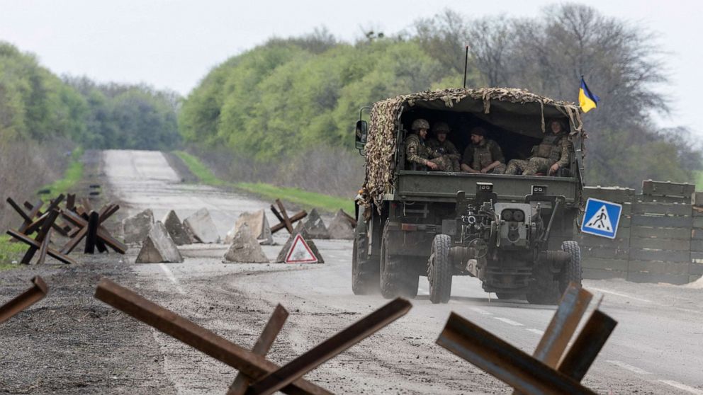 PHOTO: A Ukrainian military vehicle drives to the front line during a fight with Russian forces near Izyum in Kharkiv Oblast, eastern Ukraine, on April 23, 2022.