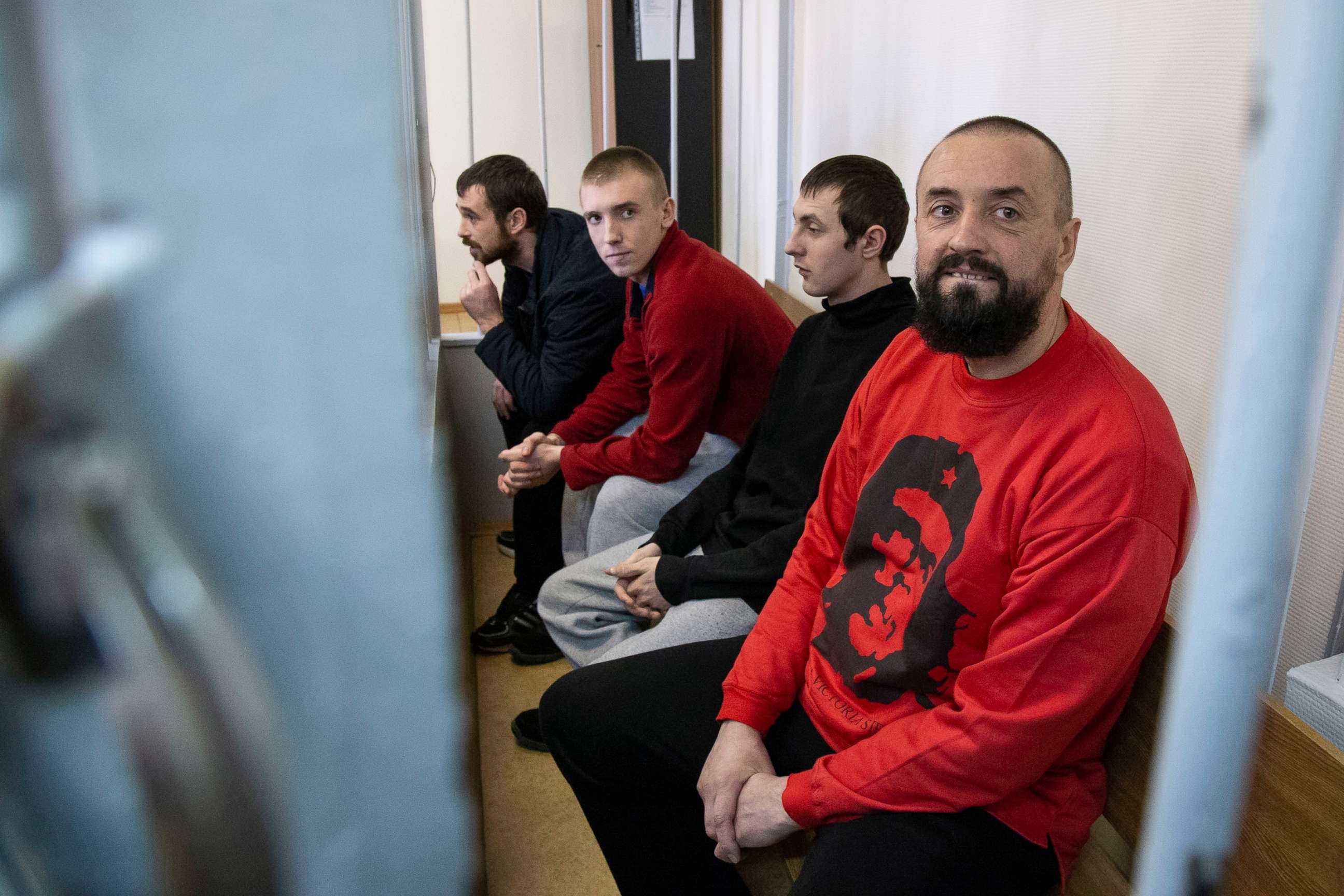 PHOTO:In this April 17, 2019 file photo Ukrainian sailors sit in a cage in a courtroom in Moscow.