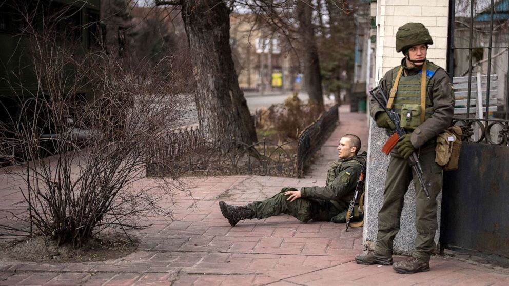 PHOTO: A Ukrainian soldier sits injured on the ground inside the city of Kyiv, Ukraine, Feb. 25, 2022. 