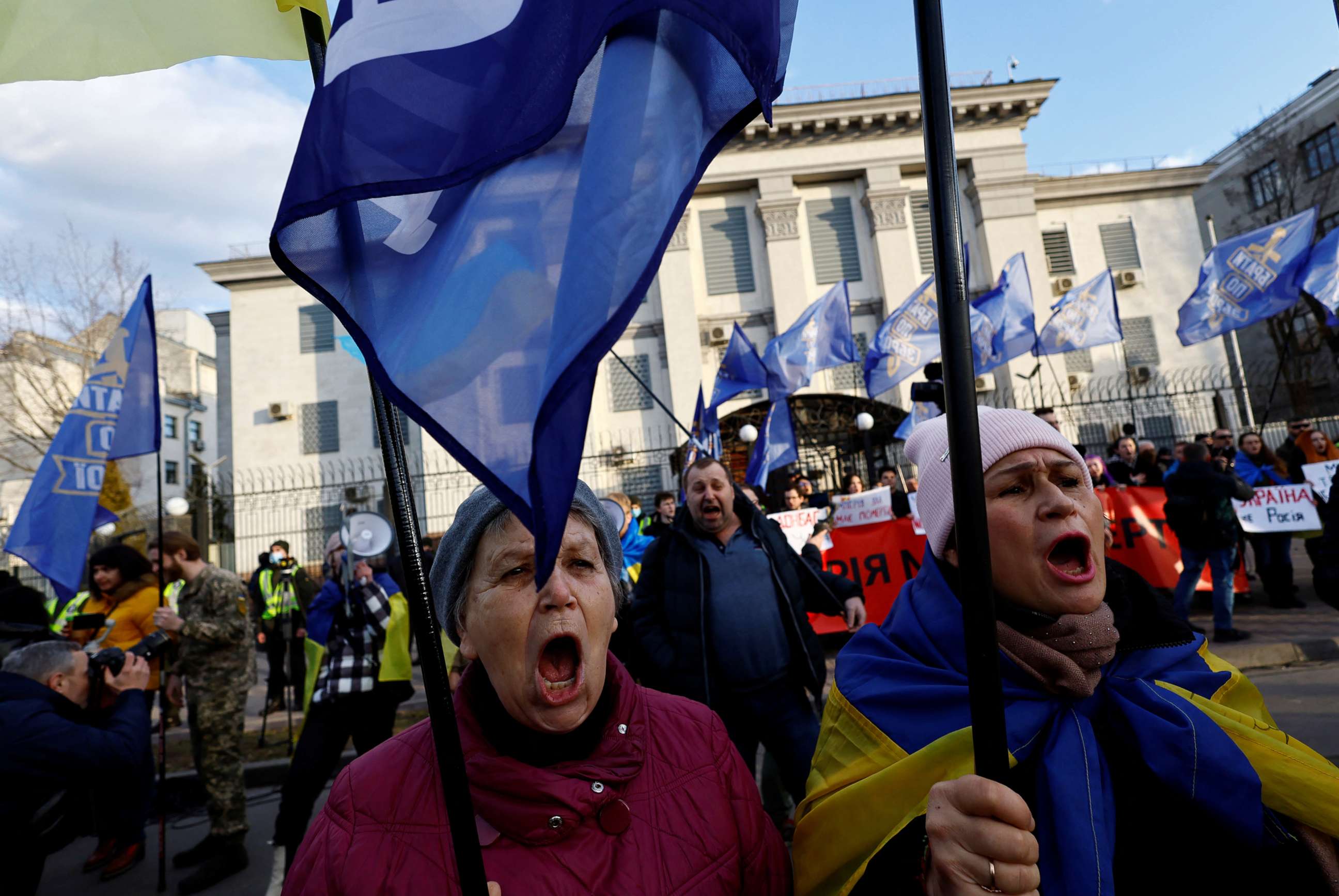 PHOTO: Ukrainians shout slogans, wave Ukrainian national and EU flags, hold banners as they protest outside Russian embassy in central Kyiv, Ukraine, Feb. 22, 2022.